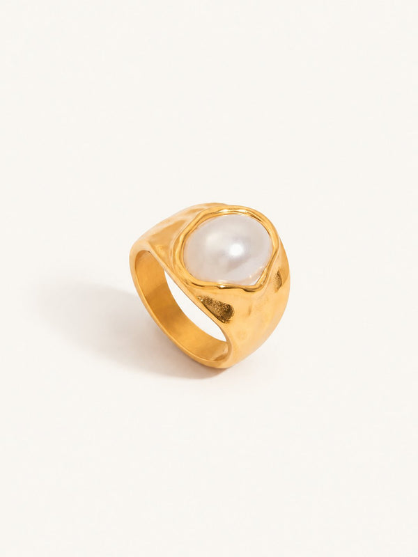 Chunky gold-tone ring set with a large white domed stone