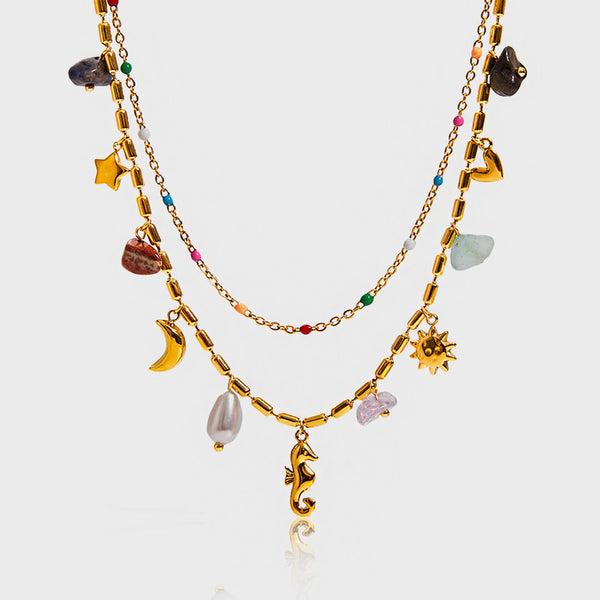 Layered chains hung with a seahorse, moon, sun, star and coloured stones