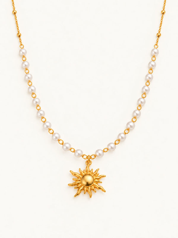 Pearl and chain necklace with a gold-tone sun pendant