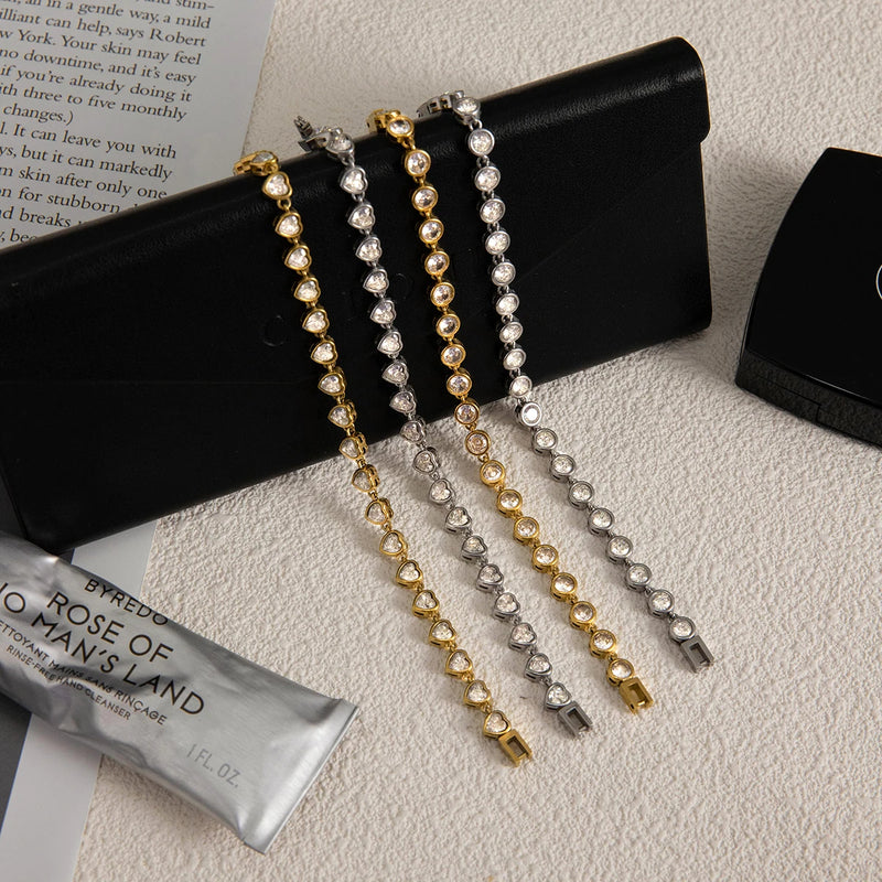 Odile Crystal Chain Bracelet, four designs laid on a black clutch