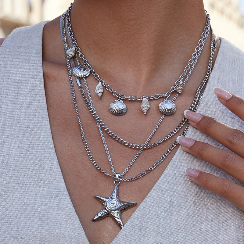 Layered silver-tone chains with a starfish pendant at the centre