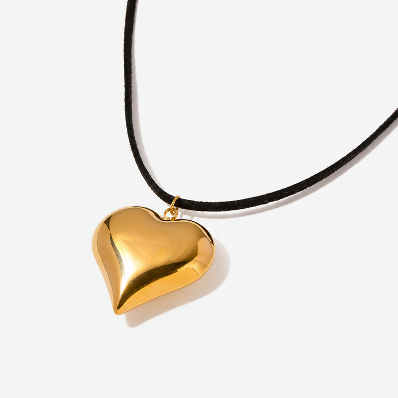 Puffed gold-tone heart pendant on a black cord