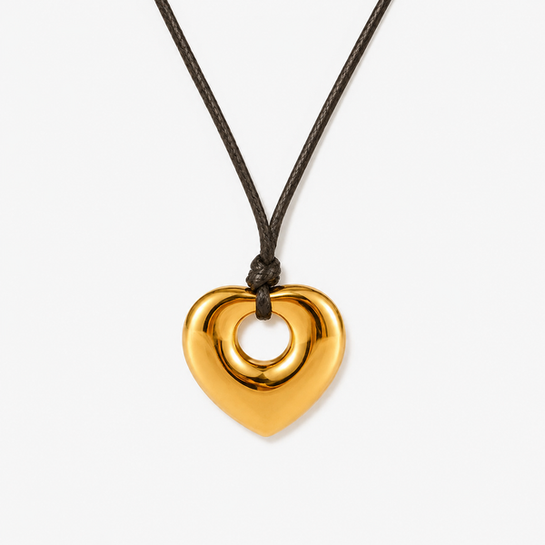 Puffed gold-tone heart with a cut-out centre on a brown cord