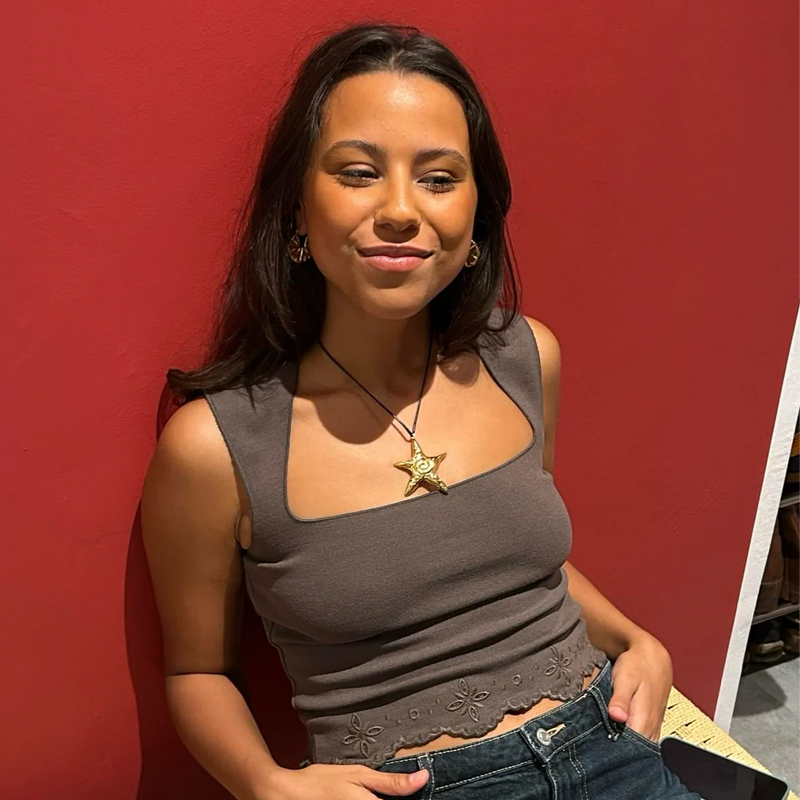 Customer photo of the starfish cord necklace worn with a top