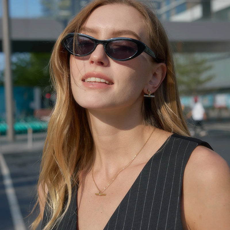 Model wearing the T-bar earrings and a fine chain necklace
