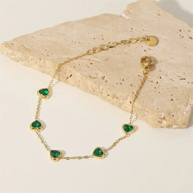 Heart station bracelet arranged on a pale stone slab