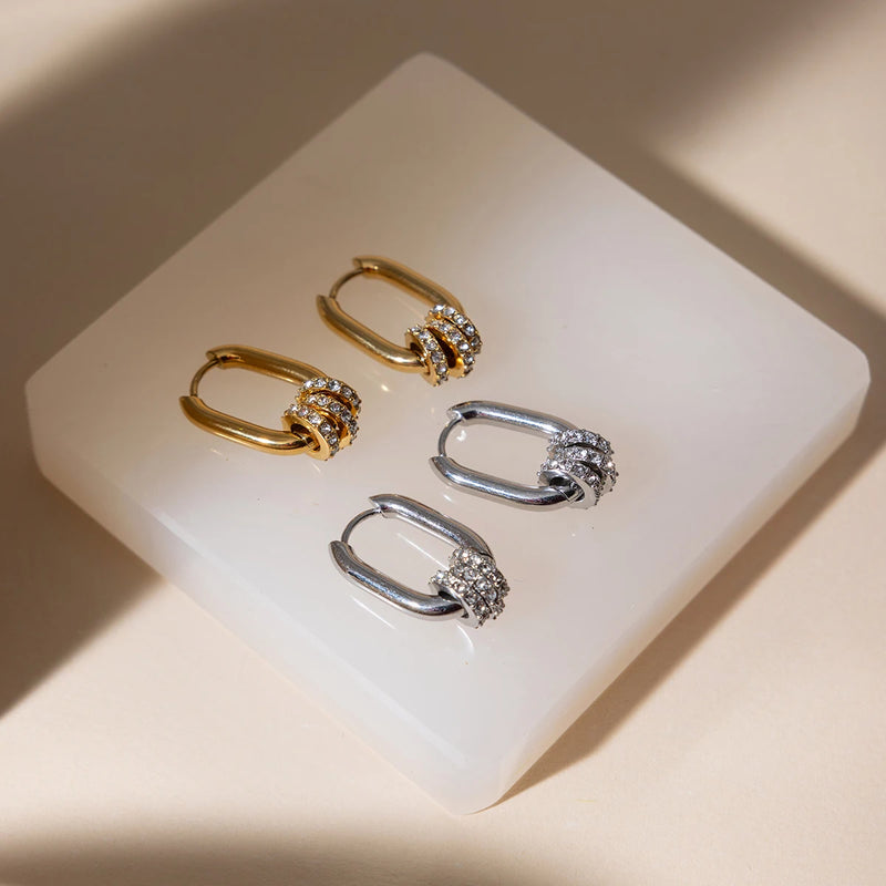 Three crystal-set oval hoops on a white block