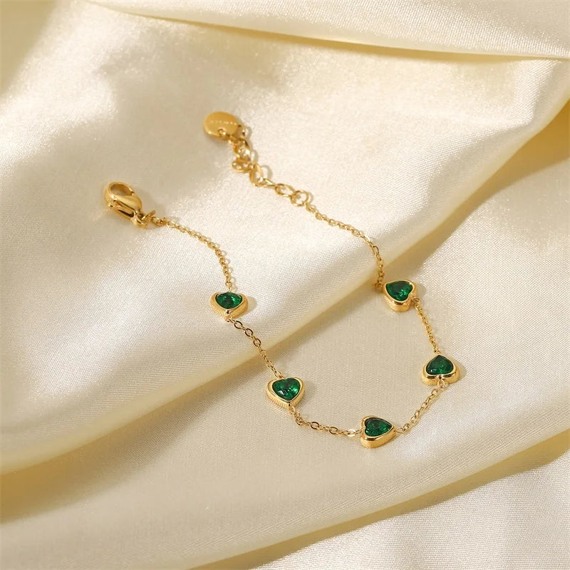 Green heart bracelet with clasp and extender on cream satin