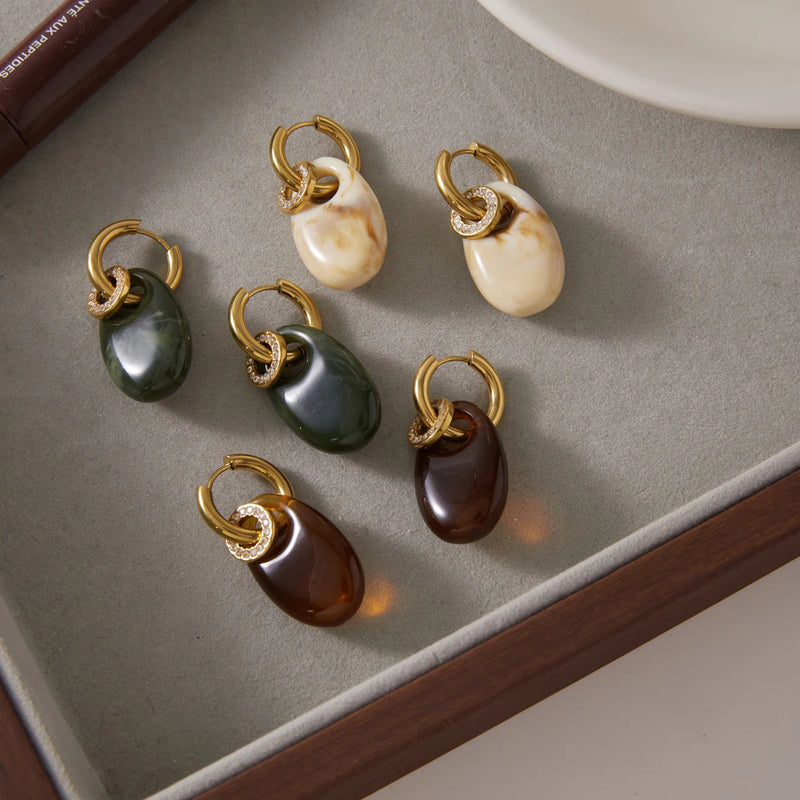 Several resin drop hoops arranged on a grey tray