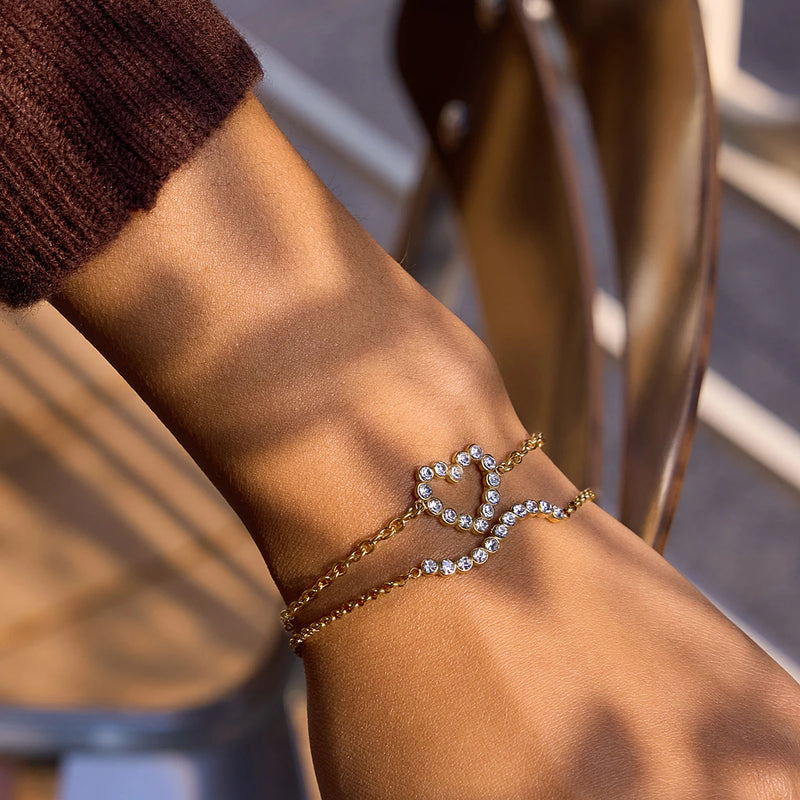 Two crystal heart bracelets worn together on a wrist