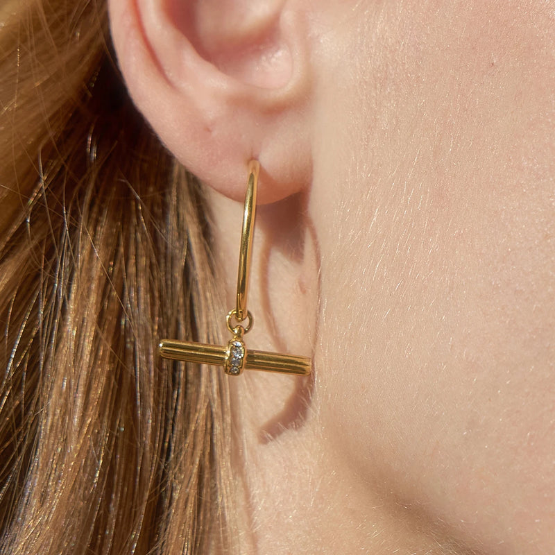 Close view of the T-bar hoop earring worn on the lobe