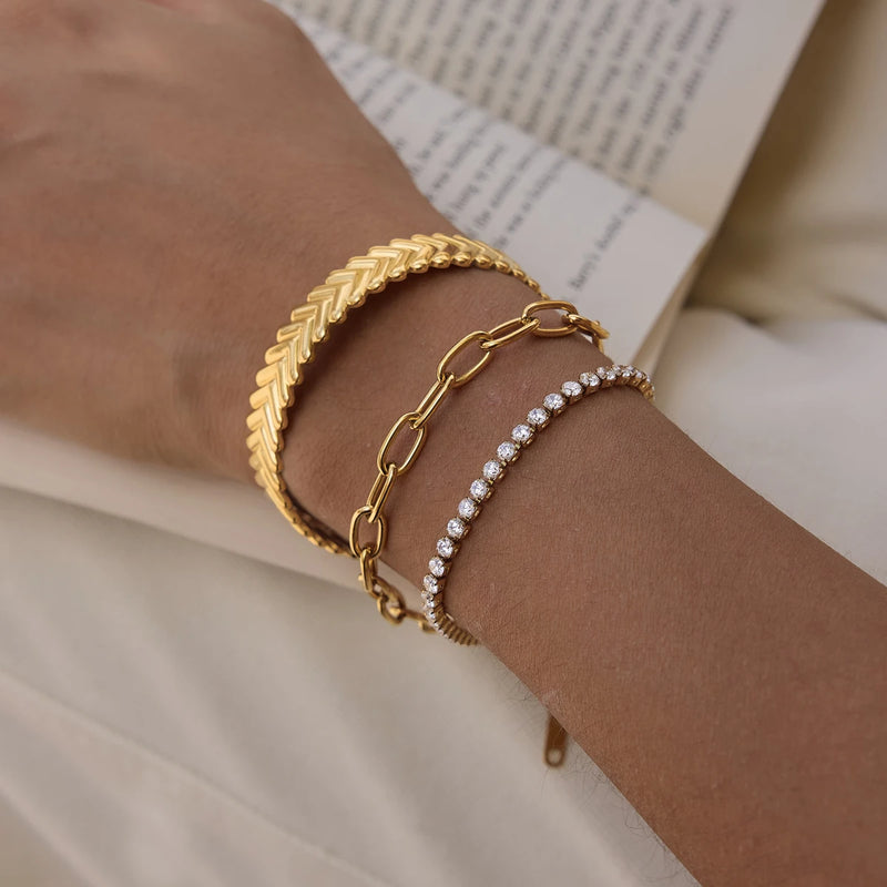Chevron cuff worn with two other bracelets on a wrist
