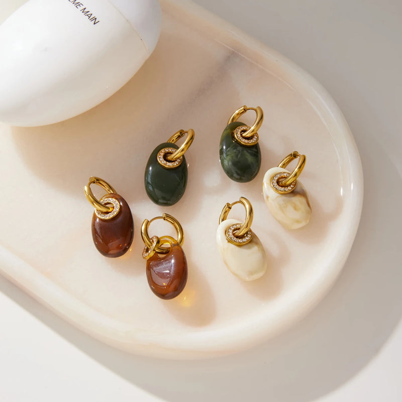 Green, brown and cream resin drop hoops on a white dish