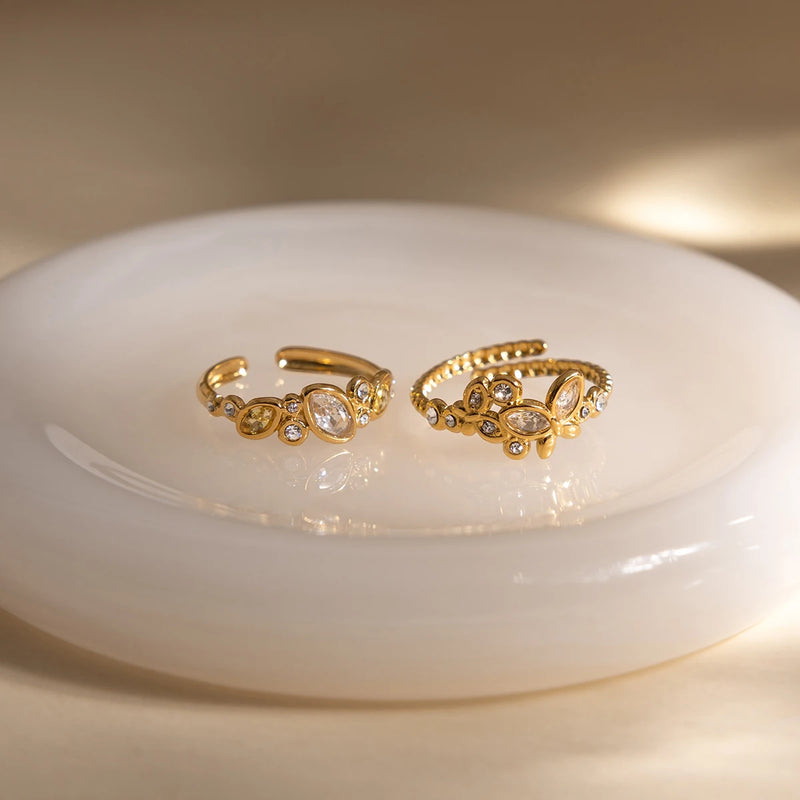 Pair of open crystal rings resting on a rounded white dish