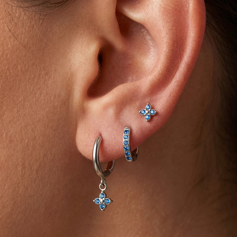 Julienne Flower Trio Earrings worn on one ear, blue stones
