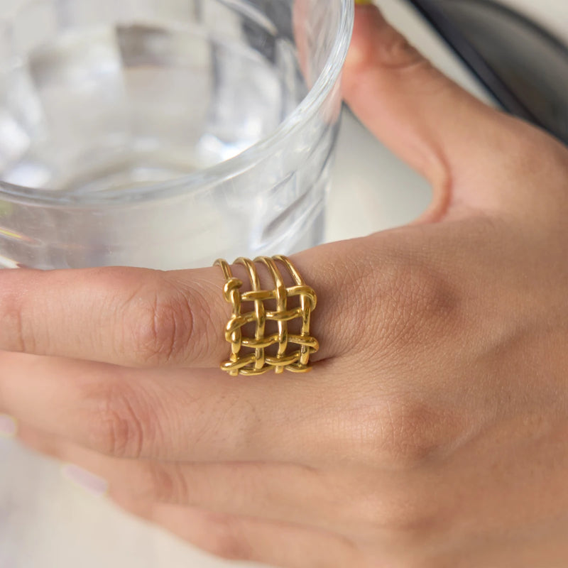Basketweave ring worn on a hand holding a glass of water