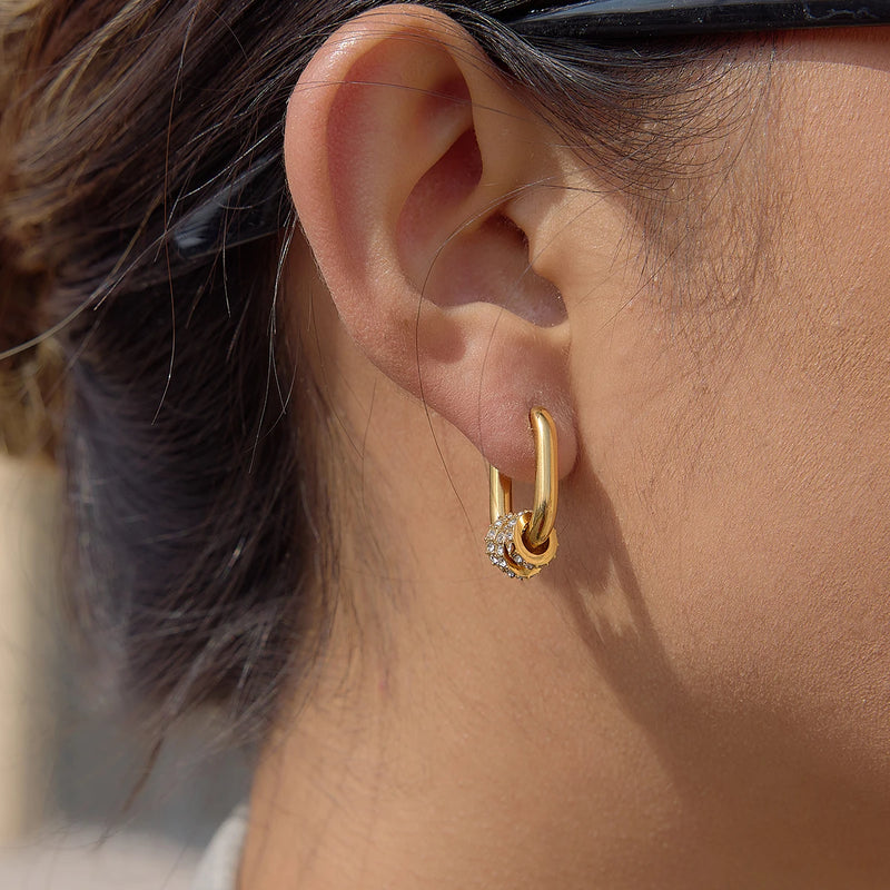 Gold-tone crystal-set oval hoop worn on the lobe