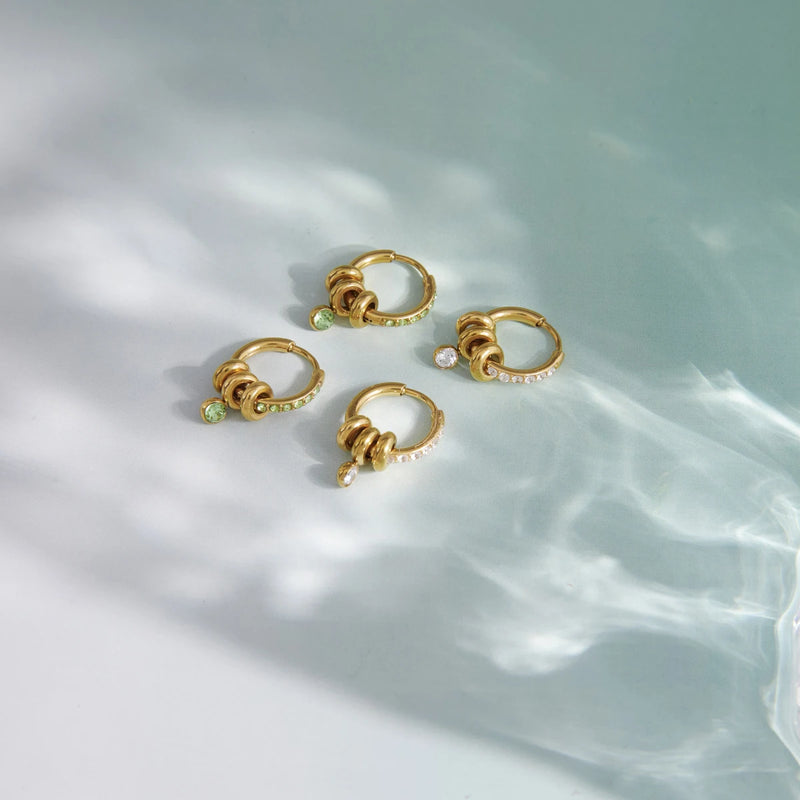Several small hoops arranged on a pale surface with water shadows