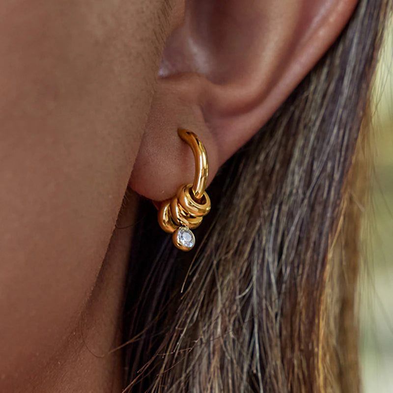 Crystal drop huggie hoop worn on the lobe, side view