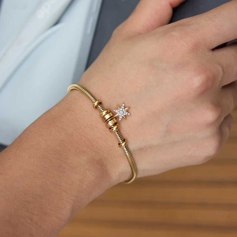 Single star charm bangle worn on a wrist