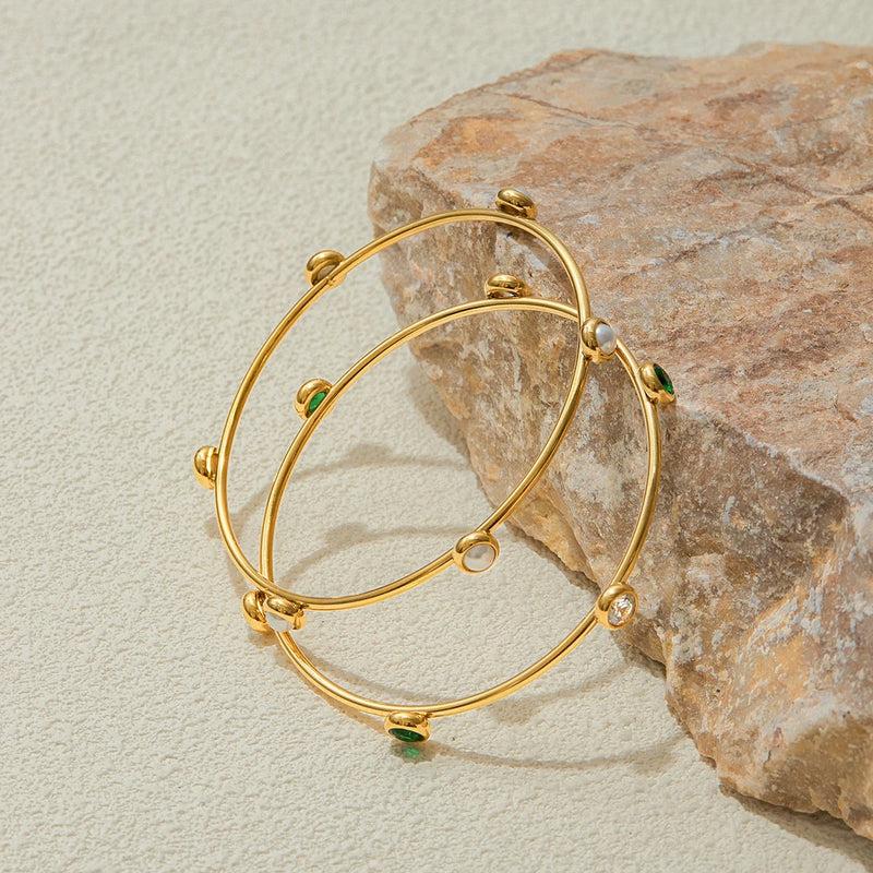 Stone station bangles leaning against pale rock