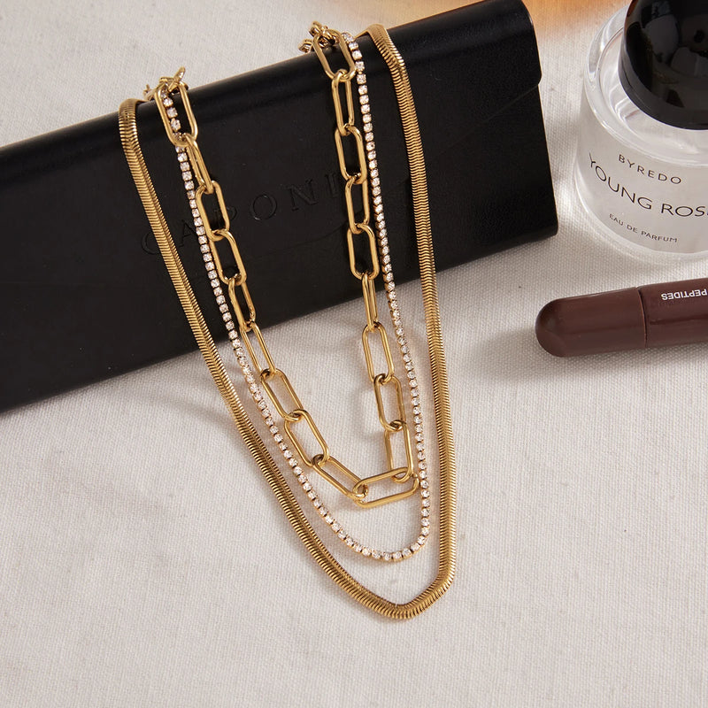 Marielle Triple-Layer Chain Necklace draped over a case, all three chains in view