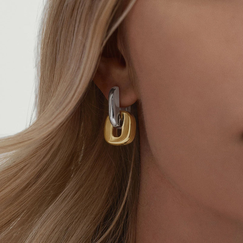 Two-tone chunky link earring worn on the lobe