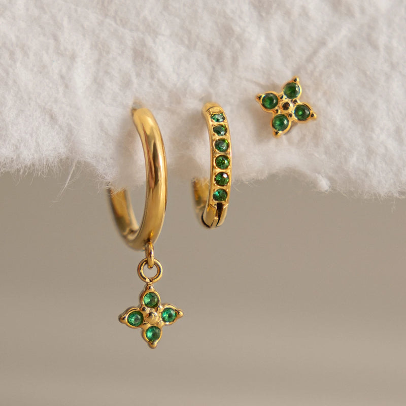 Julienne Flower Trio Earrings, the three pieces laid out with green stones