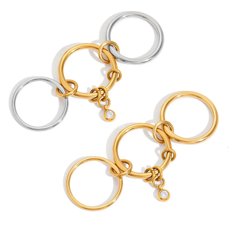 Two linked triple-band rings in gold and silver tone on white
