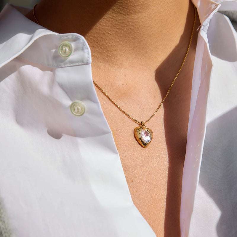 Cyrielle Crystal Heart Necklace worn alone over a white shirt