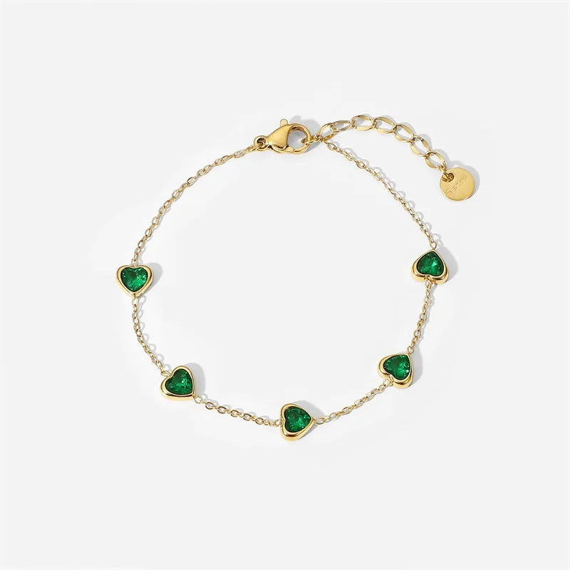 Fine chain bracelet set with small green heart-cut stones