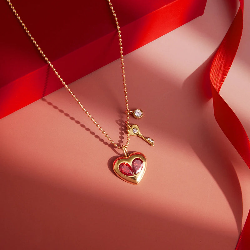 Heart and key charm necklace on a red background with ribbon
