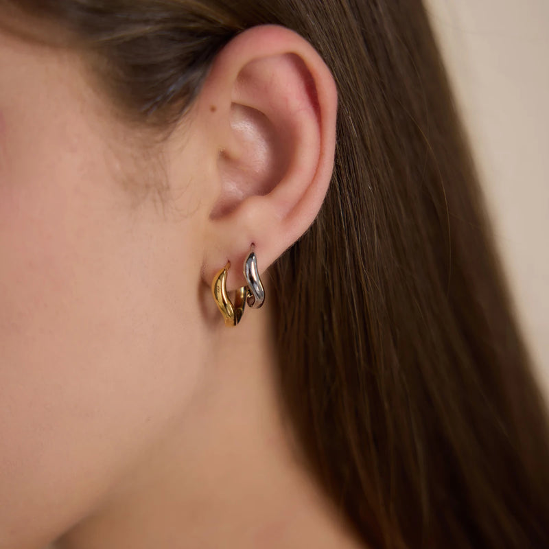 Two sculpted hoops worn together on one ear