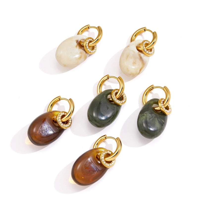 Three pairs of oval resin drop hoops in cream, green and brown