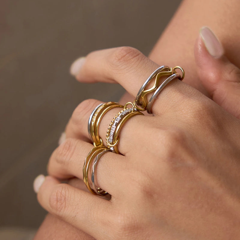 Wave rings stacked across several fingers of a hand