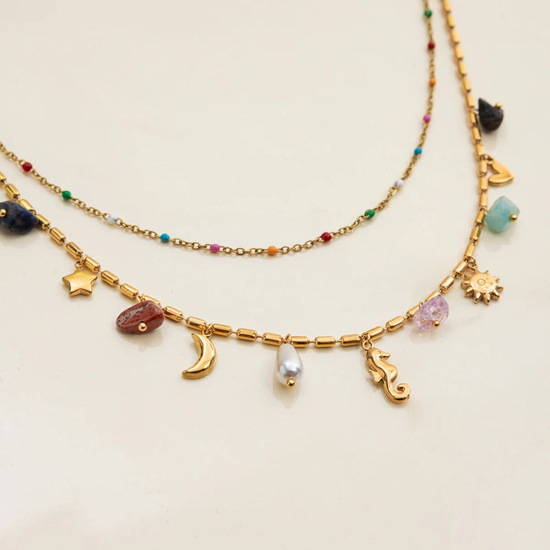 Close view of the moon, shell and seahorse charms on beaded chain