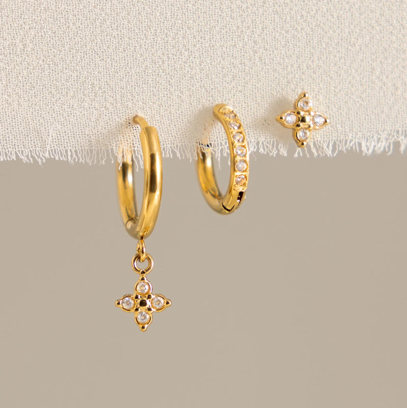Julienne Flower Trio Earrings, the three pieces laid out with clear stones