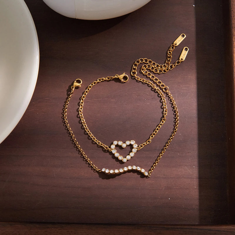 Open crystal heart bracelet on a dark wooden surface