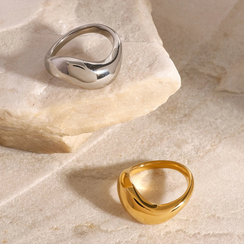 Ludivine Sculptural Wave Ring in silver-tone, propped against pale stone