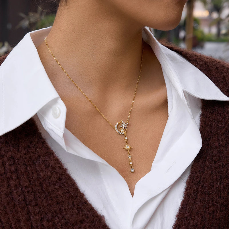 Angele Crystal Lariat Necklace worn, star and moon charms falling below the collarbone