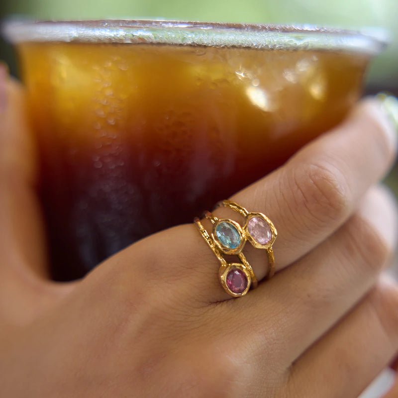 Aude Multi-Stone Ring worn while holding an iced drink