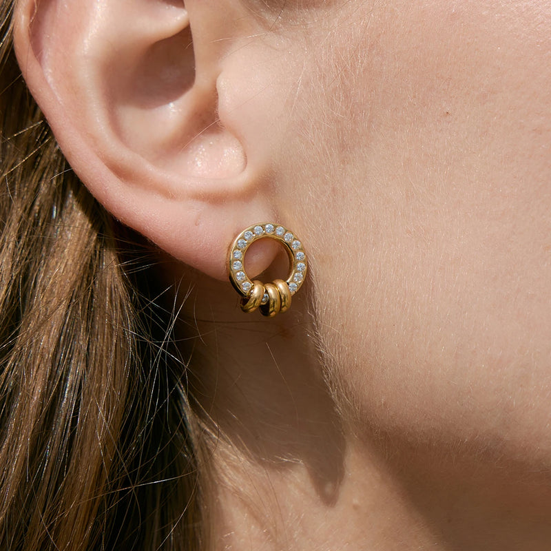 Small crystal-set circle earring worn on the lobe