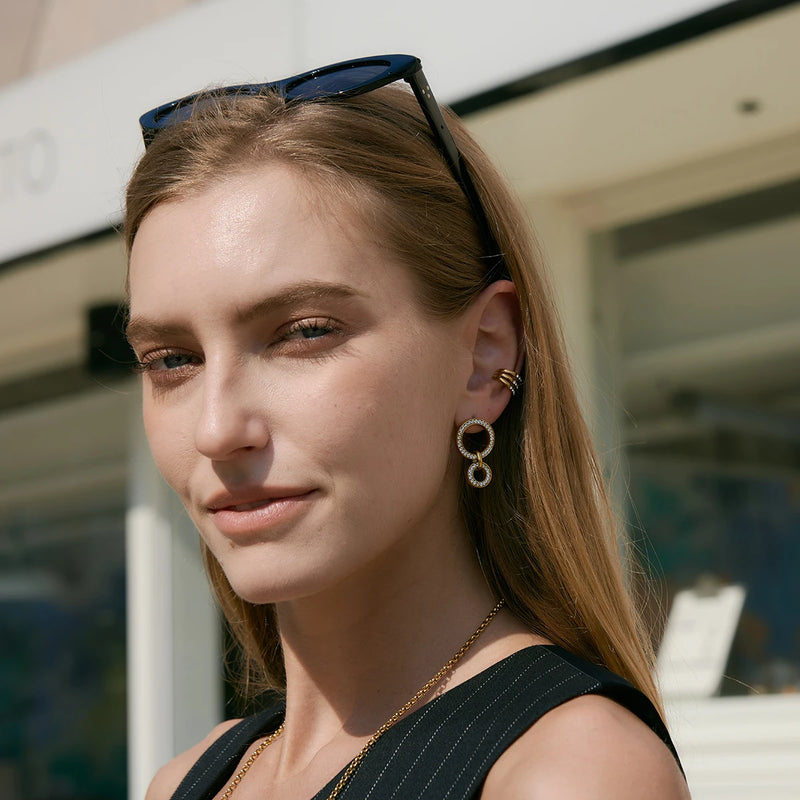 Circle link drop earrings worn with sunglasses on the head