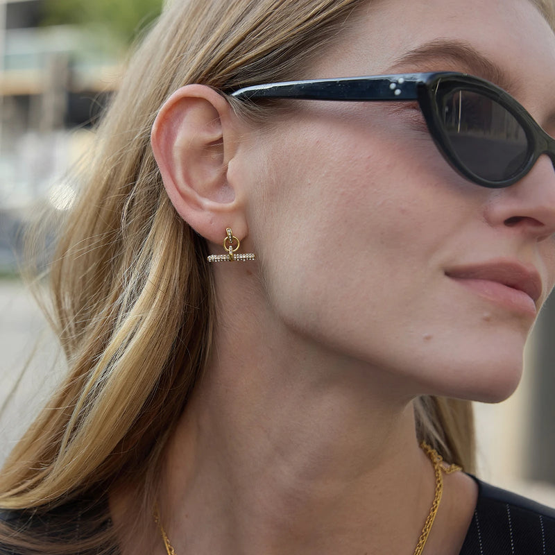 Pave T-bar earrings worn with sunglasses, side view