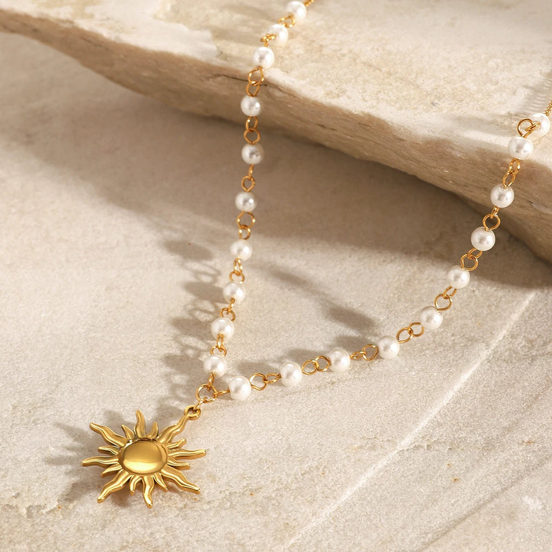Close view of the sun pendant on the pearl chain