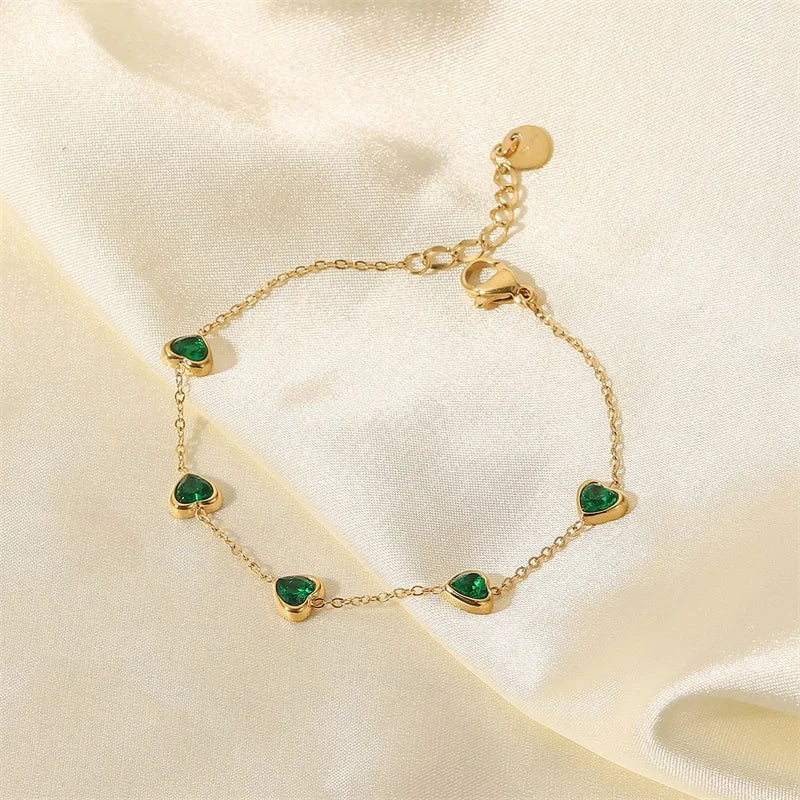 Chain bracelet with green heart stations on cream satin