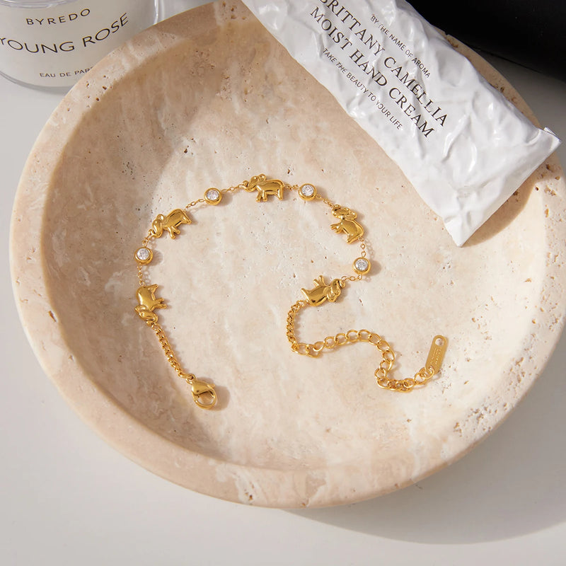 Elephant charm bracelet in a pale stone dish