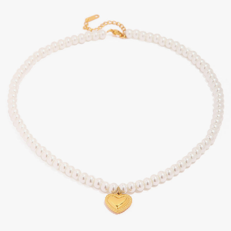 Pearl bead necklace with a small gold-tone puffed heart pendant