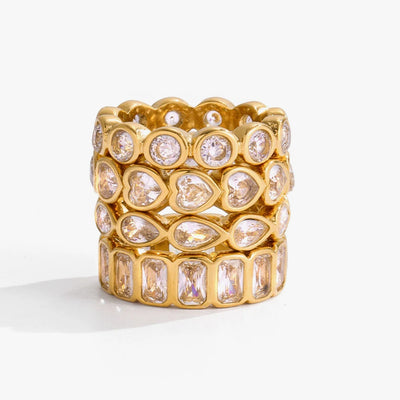 Wide band ring set with rows of clear crystals in mixed shapes