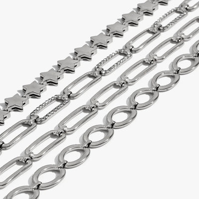 Silver-tone star, paperclip and oval-link chain bracelets laid side by side